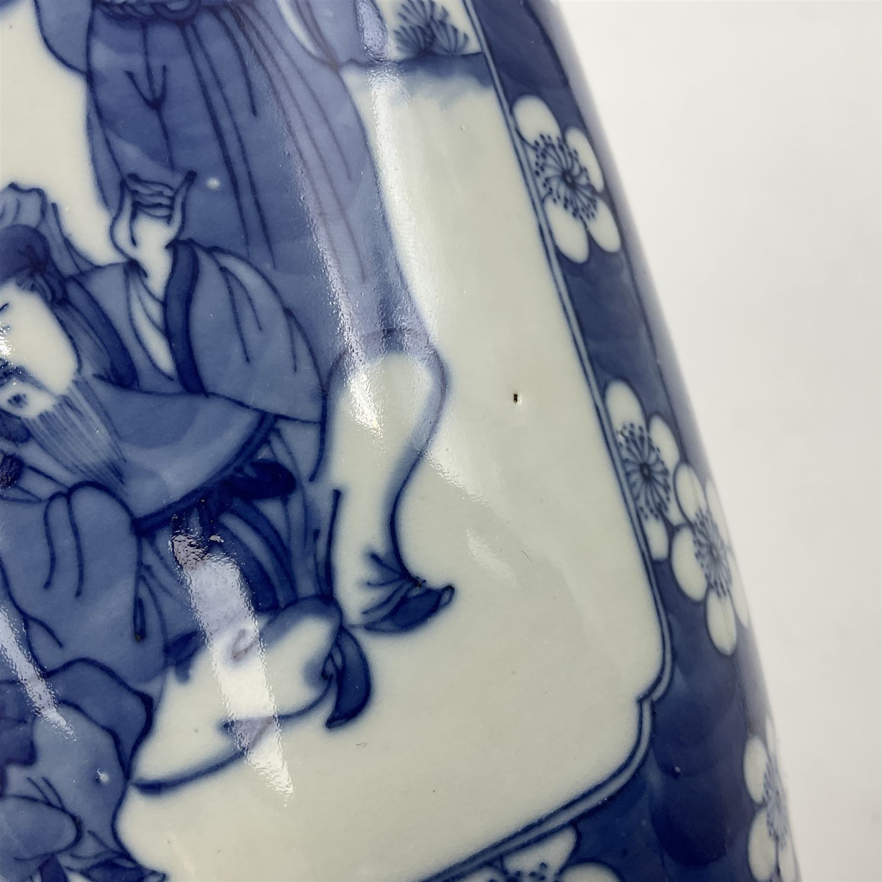 Late 19th century Chinese blue and white jar and cover, of slender ovoid form with domed cover, decorated with two reserves containing figures, against a prunus blossom ground, with Kangxi type mark beneath, H27.5cm