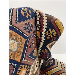 Late 20th century beech framed wingback armchair, sprung seat and back upholstered in kilim cover, acanthus carved cabriole supports with ball and claw feet