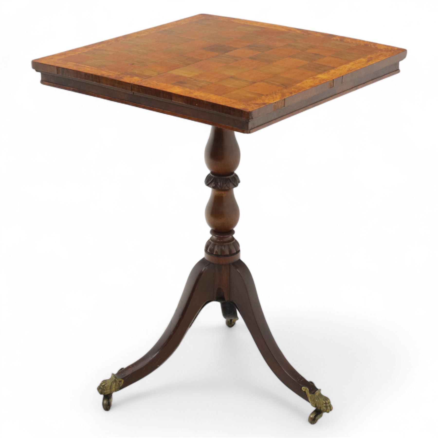 Early 20th century walnut chess table, square checkered veneered top with crossbanded edge, raise on a turned column based with acanthus craving, on three outswept legs terminating in brass paw caps above castors