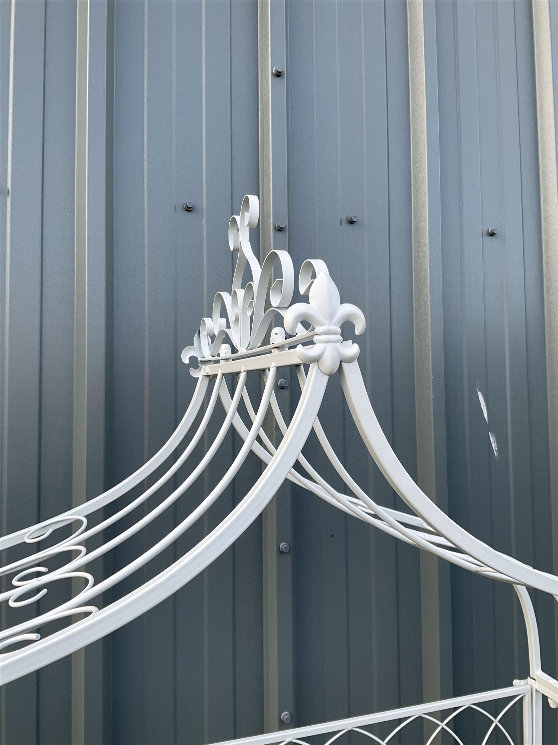 White painted metal garden arbour bench, pagoda top with sunrise back - THIS LOT IS TO BE COLLECTED BY APPOINTMENT FROM DUGGLEBY STORAGE, GREAT HILL, EASTFIELD, SCARBOROUGH, YO11 3TX