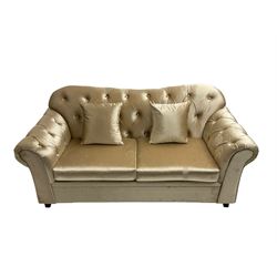 Chesterfield shaped two seat sofa, upholstered in buttoned champagne fabric, with scatter cushions