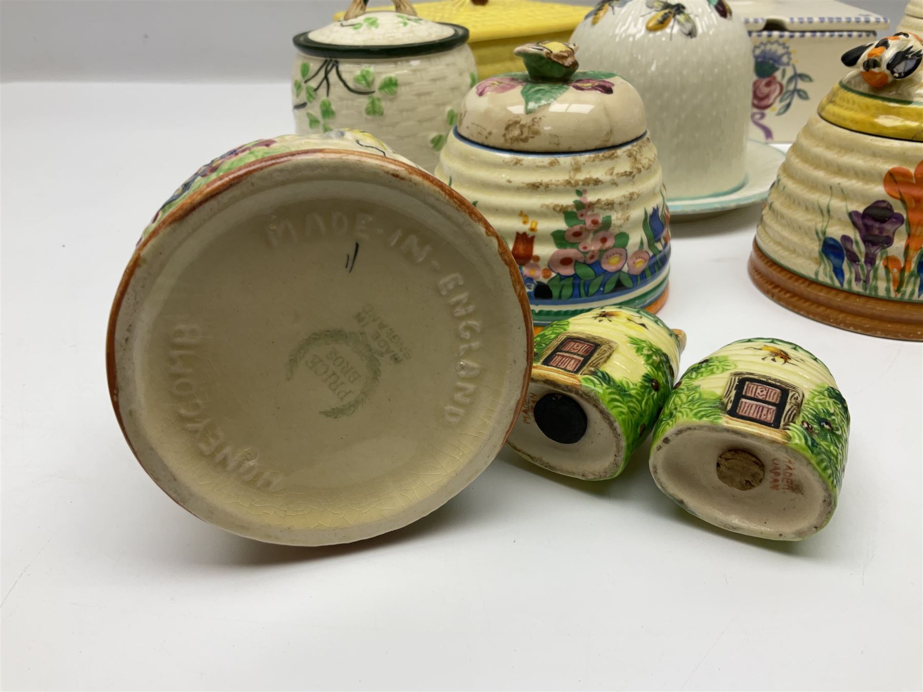 Clarice Cliff for Wilkinson Ltd Crocus Bizarre beehive honeypot painted in the Crocus pattern, together with two beehive Beswick honey pots, Poole square honey pot etc (14)