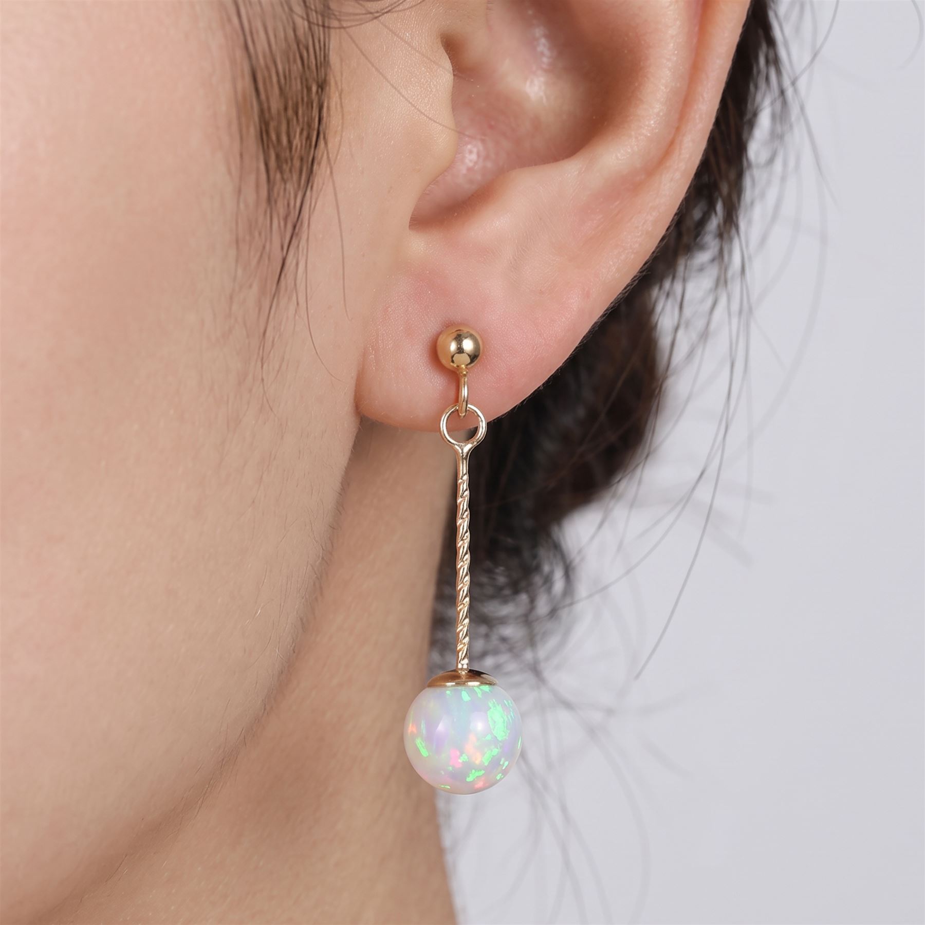 Pair of 9ct gold opal pendant stud earrings, stamped