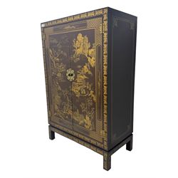 Chinese brown lacquered cocktail cabinet, decorated with gilt scenes of a traditional landscape with figures, pagodas, and mountainous scenery, double doors opening to reveal fitted interior with mirrored back, wine rack, shelves and cupboard, raised on square supports