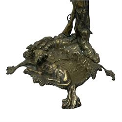 Pair of cast brass hallway umbrella or stick stands, in the form of a tree decorated with trailing flowering foliage branches, the stem with hunting horn over leaning shotgun, shaped naturalist tray base with hunting hound and out splayed foliate cast feet 