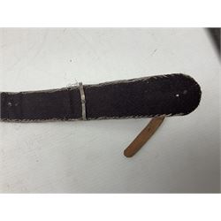 Omani Khanjar dagger, the 19cm curved blade with pronounced medial rib to either side, waisted hilt with dome shaped pommel and silver covered horn grip decorated with filigree bands, floral motifs and beadwork; in an intricately filigree decorated silver and leather scabbard with silver rings woven into the belt mount and fitted with original silver thread-work belt L34cm overall belt length 94cm