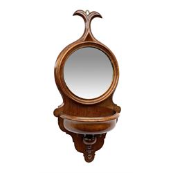 Victorian mahogany mirror backed wall bracket in the form of a stoop, the circular mirror plate set against a shaped mahogany back with turned detail beneath a semi-circular well, H67.5cm