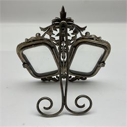 Early 19th century silver plated double photograph frame, each rounded rectangular aperture surrounded by a paste border, with ornate scroll feet and mantling also set with clear paste stones, with easel style support verso, H12cm