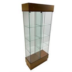 Light oak and glass double display cabinet, glazed back and sides with two divisions, each with three shelves, light fitting to top of each section