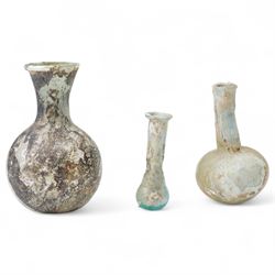 Three Roman glass funerary vessels c. 1st-3rd Century A.D., comprising a group of free-blo...