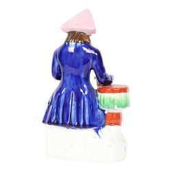 Mid 19th century Staffordshire figure of a Greenwich Hospital pensioner, circa 1850, modelled as a seated sailor with a peg leg, his left arm holding a goblet, his right leaning upon a table and holding a jug, wearing naval uniform and tricorn hat, H21cm
