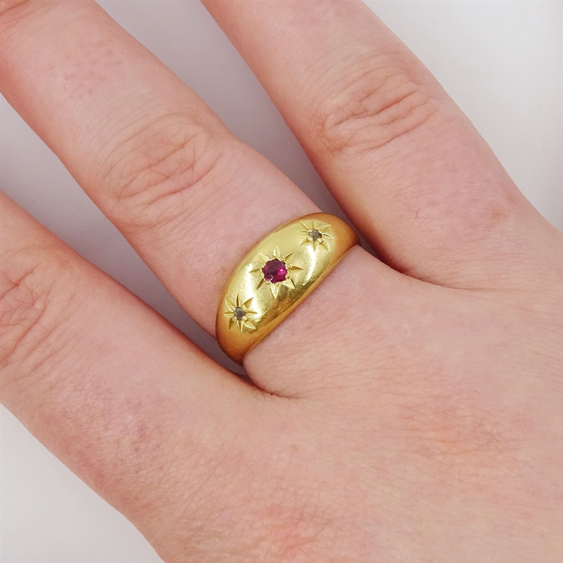 Early 20th century 18ct gold ruby and diamond gypsy ring, single round cut ruby with a rose cut diamond set either side, Chester 1919