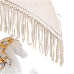 Italian-style ceramic table-lamp featuring two white running horses with gold accents, with cream tasselled lampshade, upon a wooden base, approx. H60cm W40cm