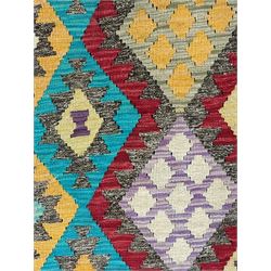 Anatolian Kilim cream ground rug, decorated with repeating diamond motifs in red, blue, yellow, and green, bordered by narrow bands of stylised geometric patterns in contrasting shades