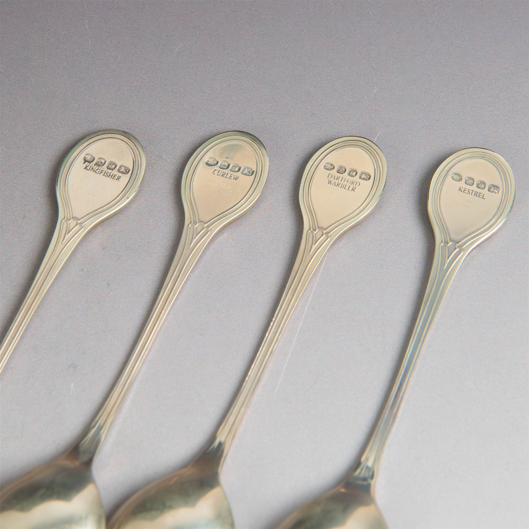 Royal Society for The Protection of Birds silver spoon collection, twelve spoons each inset with a silver-gilt bird cameo, hallmarked John Pinches Ltd, London 1975, in wooden presentation case with certificate of authenticity