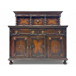 Jacobean-style oak dresser base with two frieze drawers above three cupboards with panelle...
