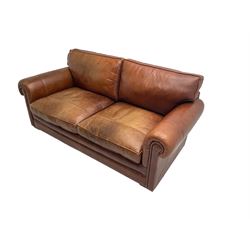 Large two seat sofa upholstered in tan 'Derwent' leather (W200cm D100cm H85cm), and matching armchair (W95cm)