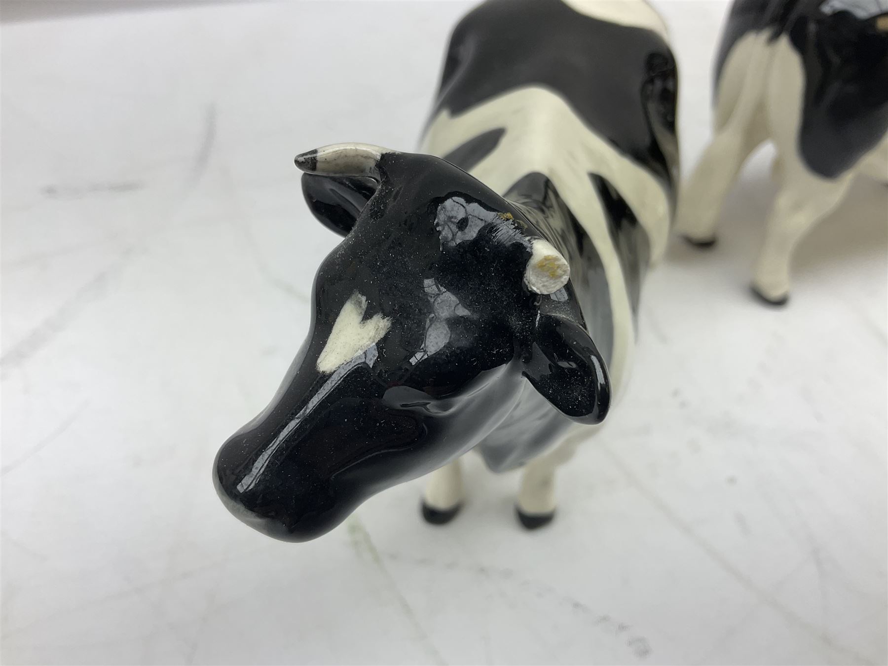 Seven Beswick cow figures, to include Friesian bull Ch. ''Coddington Hilt Bar'' no. 1439a, Friesian cow Ch. 'Claybury Leegwater' no. 1362a and Friesian calf no. 1249C, Aberdeen Angus calf 1827a, Jersey cow no. 1345 etc, all with printed mark beneath  