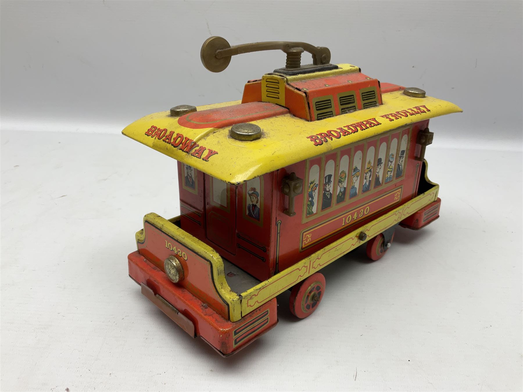 Chad Valley '0' gauge - clockwork tin-plate train set comprising LMS 0-4-0 tender locomotive No.3402 with two open wagons, loop of track and wooden signal; unboxed; and Japanese battery operated tin-plate Broadway Trolley bus No.10430