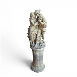 Composite garden statue group of Romeo and Juliet embracing, the couple adorned in Medieval dress standing on a naturalistic base with fallen flowers, raised on a Neoclassical fluted pedestal with Anthemion leaf motifs
