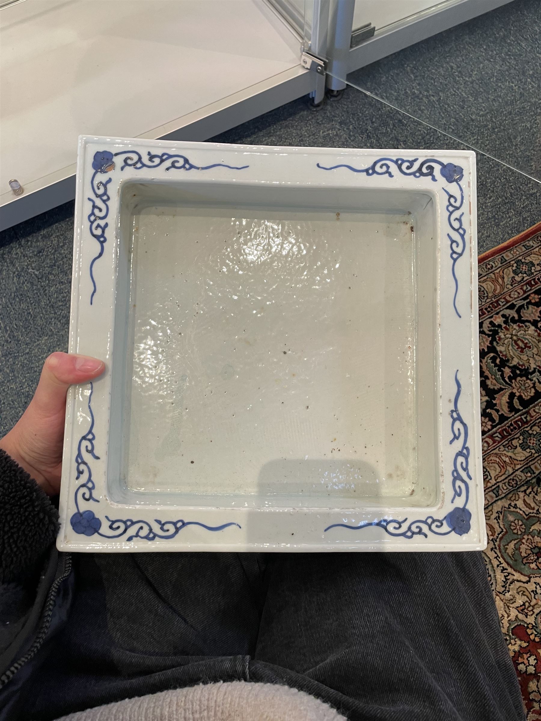 Chinese blue and white planter and stand, each of square slightly tapering and flared form, the planter decorated with two dragons and blossoming peonies, between stylised borders, the stand decorated with flower heads and vines, planter H30cm W29cm, stand H7cm D28.5cm