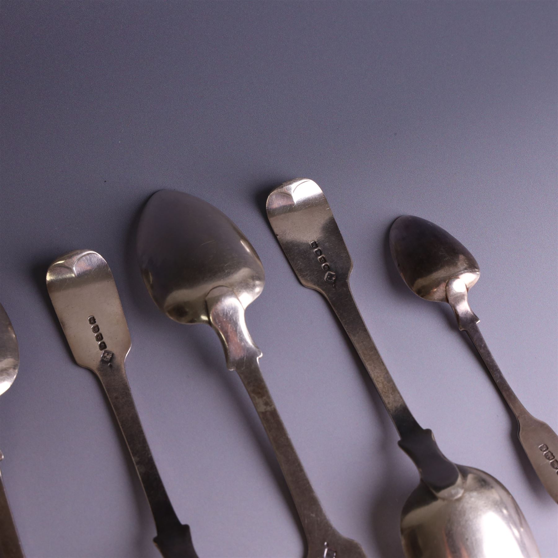 Set of four George III silver Fiddle pattern table spoons all engraved with monogram, hallmarked Thomas Wallis (II) & Jonathan Hayne, London 1819, together with a  Victorian silver Fiddle pattern teaspoon with engraved initials, hallmarked William Rawlings Sobey, Exeter 1846