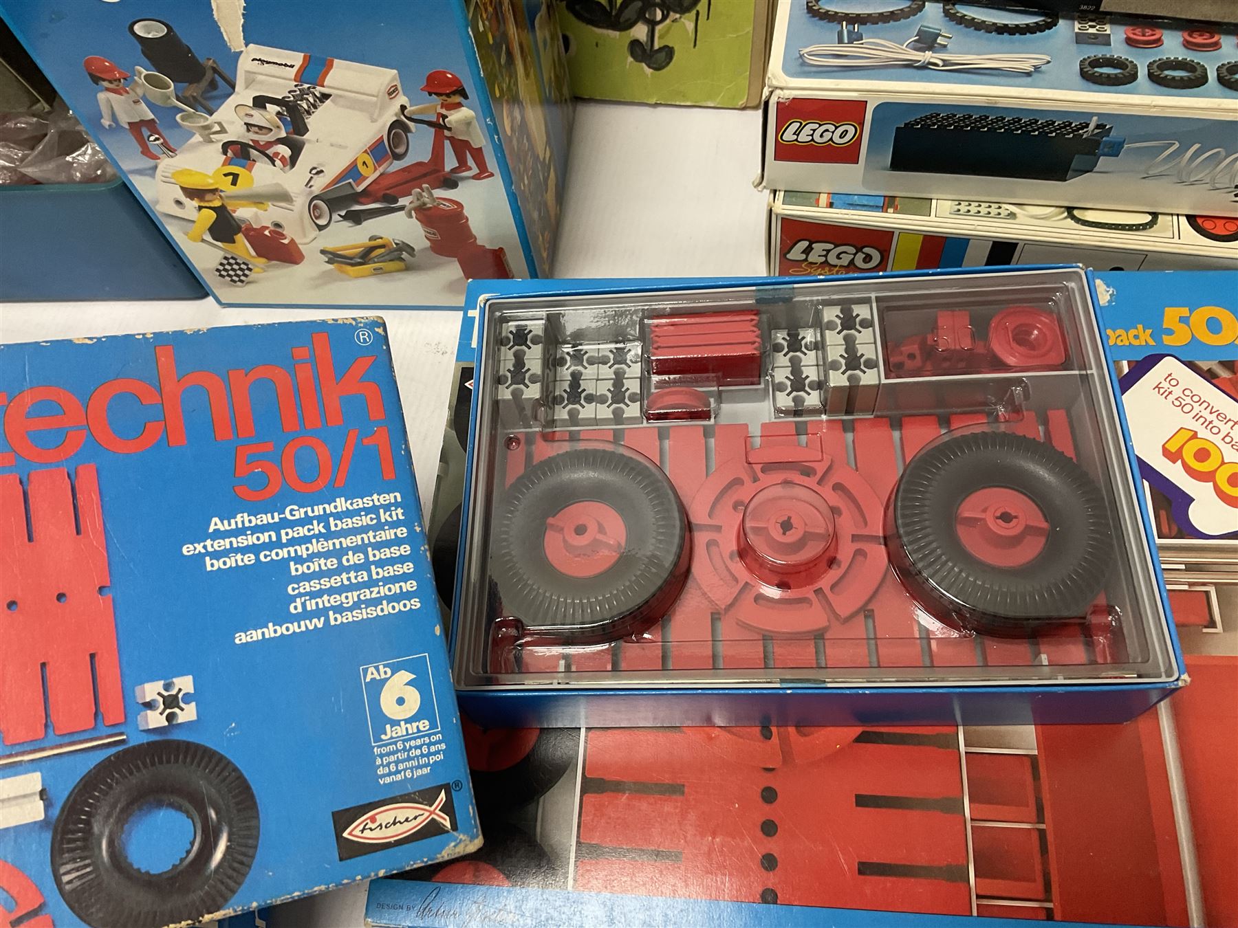 Fischer Technik/Lego/Playmobil - thirteen model building sets comprising eight Fischer Technik sets 50, 50/1, 50v, 50/2, 50+mot1 and two 50S, 50/1 add-on pack, with spare parts packs 01, 03, 05, two 22 and 30; two Lego sets comprising C107 and Lego Systems 103, part-set 870 and 970; Playmobil no.3520 set; four boxes of loose lego, various instruction manuals and a scrapbook 