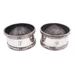 Pair of mid 20th century Scottish silver napkin rings, each with raised Celtic knot design borders and engraved initials to body, hallmarked Francis Howard Ltd, Edinburgh 1963