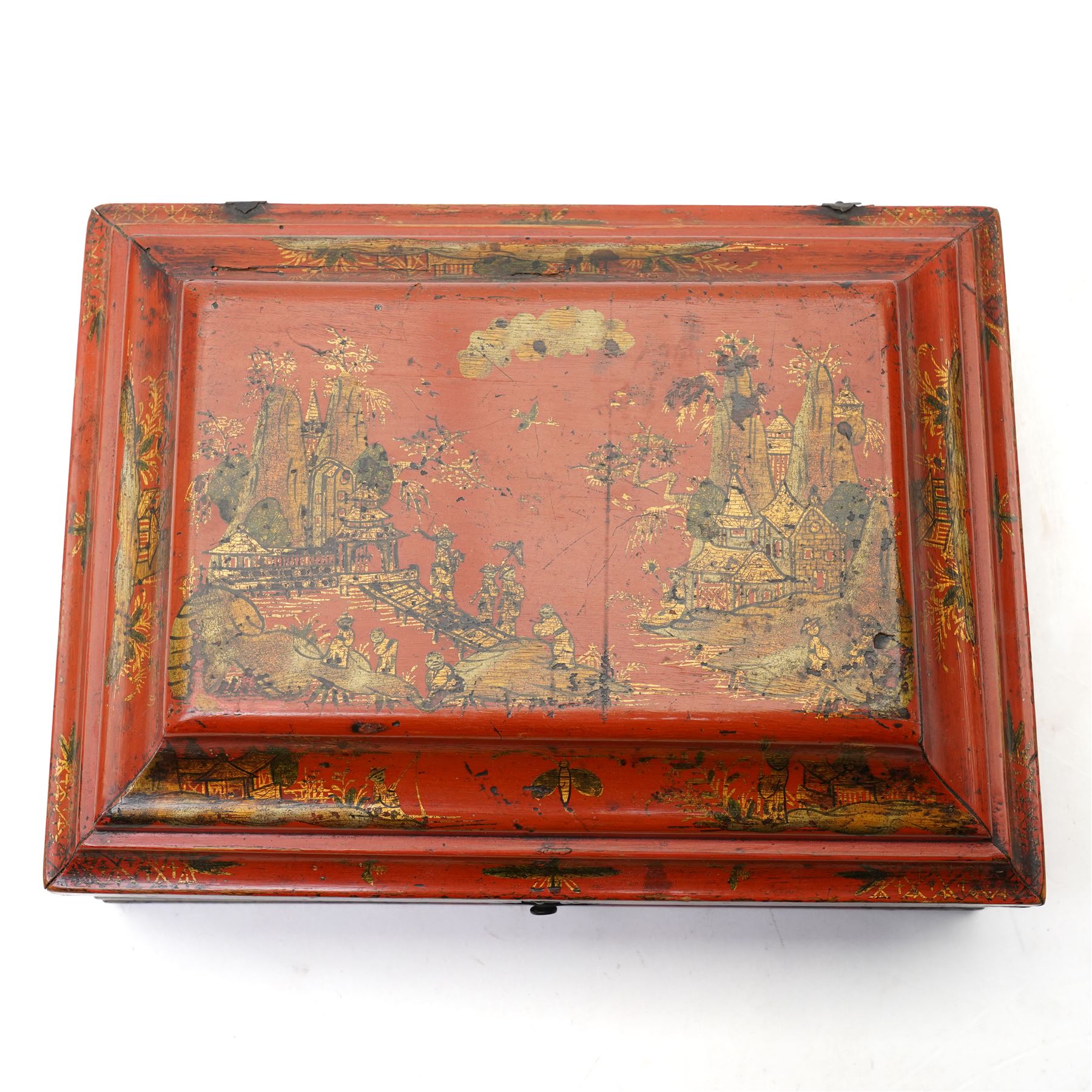 Early 19th century red lacquered chinoiserie box, painted with a traditional landscape scene and heightened in gilt, with original metal fastenings and hinges, W29cm 