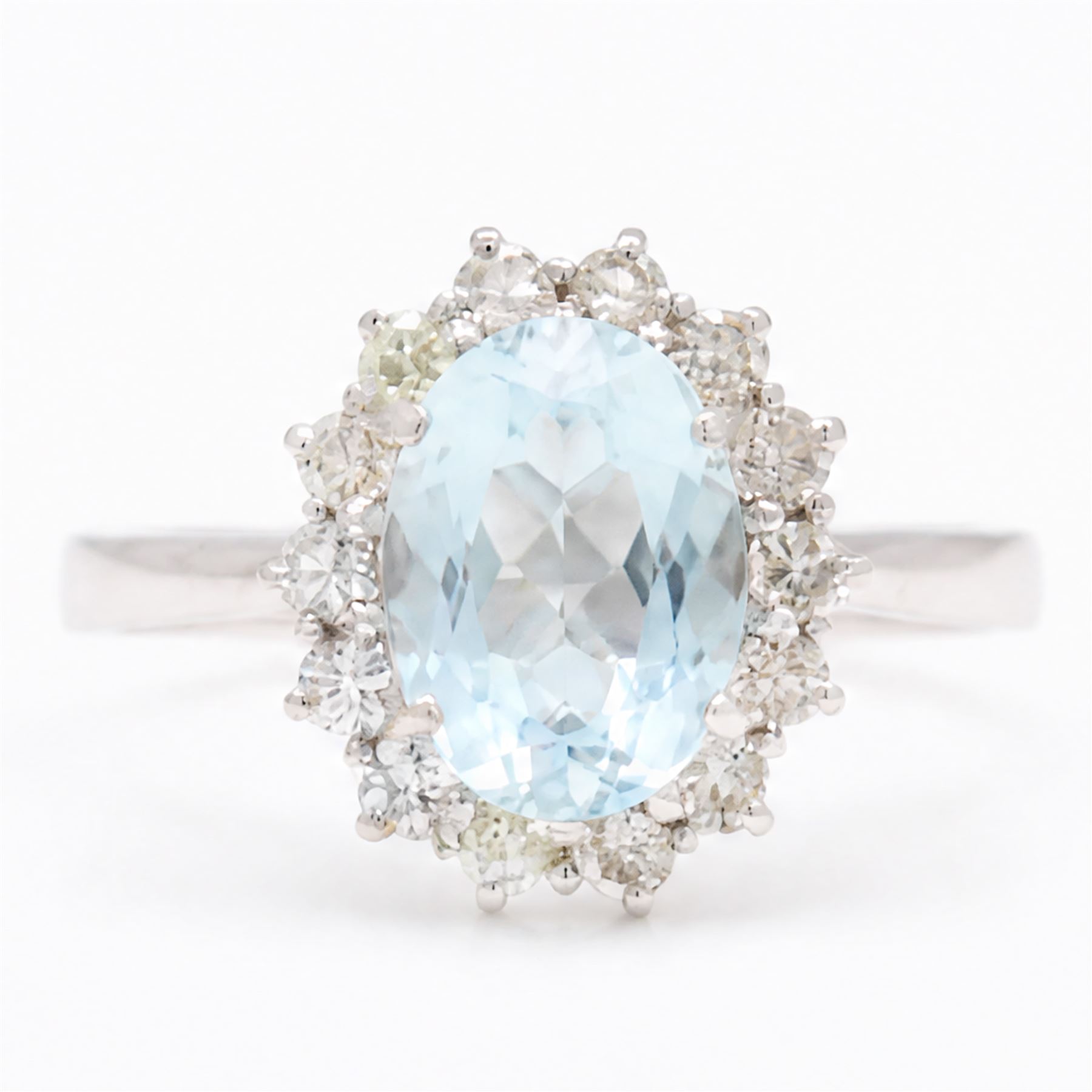18ct white gold aquamarine and diamond cluster ring, single oval cut aquamarine of approx 1.95 carat, surrounded by fourteen round brilliant cut diamonds, London 2022, total diamond weight approx 0.50 carat