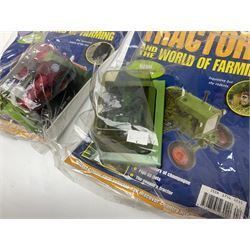 Eighteen issues of Tractors and The World of Farming magazine, together with sixty diecast tractors, all in original packaging, in three boxes 