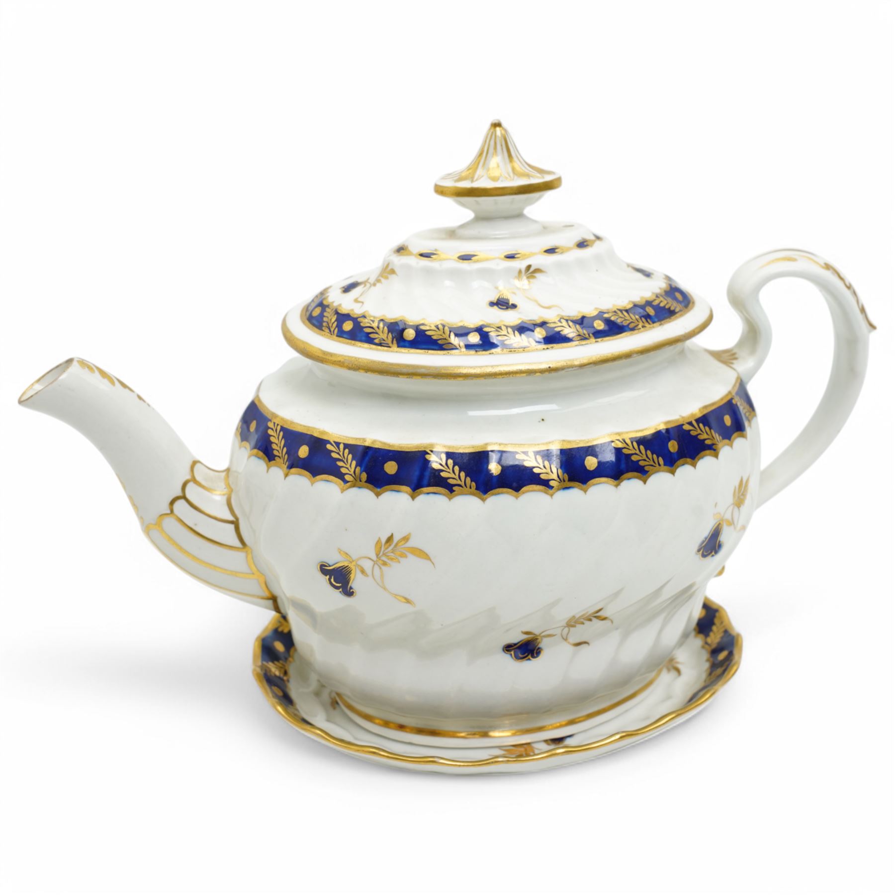 18th century Worcester teapot and stand of oval wrythen form decorated with flowers and leaves in blue and gilt, with blue crescent mark