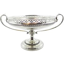 Early 20th century silver twin handled pedestal bowl, the bowl of circular form with engraved initials and date to interior, pierced rim above a bead and dart border, and twin scroll handles, upon a knopped stem and spreading circular base with conforming bead and dart band, hallmarked Sibray, Hall & Co Ltd, London 1917, including handles H16.5cm rim D22.5cm, approximate weight 30.18 ozt (939 grams)