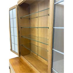 'Mouseman' oak display cabinet on cupboard, raised cabinet enclosed by two lead glazed doors, adzed oak top over double panelled cupboard, fitted with ironwork and carved with mouse signature, by Robert Thompson of Kilburn