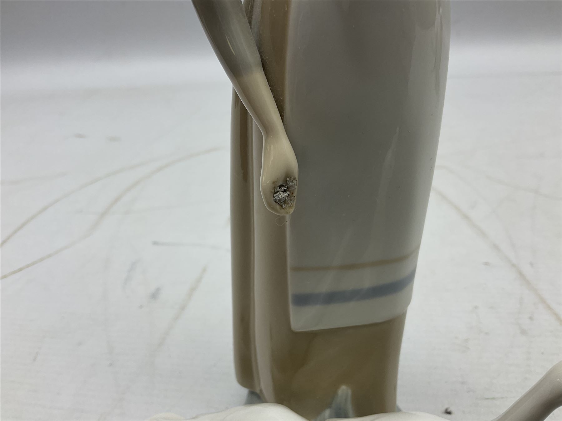 Seven Lladro figures, comprising Playful Puppy no 9135, Platero and Marcelino/Boy Hugging Donkey no 1181, Mini Seal Family no 5318, Attentive Polar Bear no 1207, Seated Polar Bear no1209, Eskimo Boy with Pet no 5238 and Girl with Geese no 1035, together with Nao goose