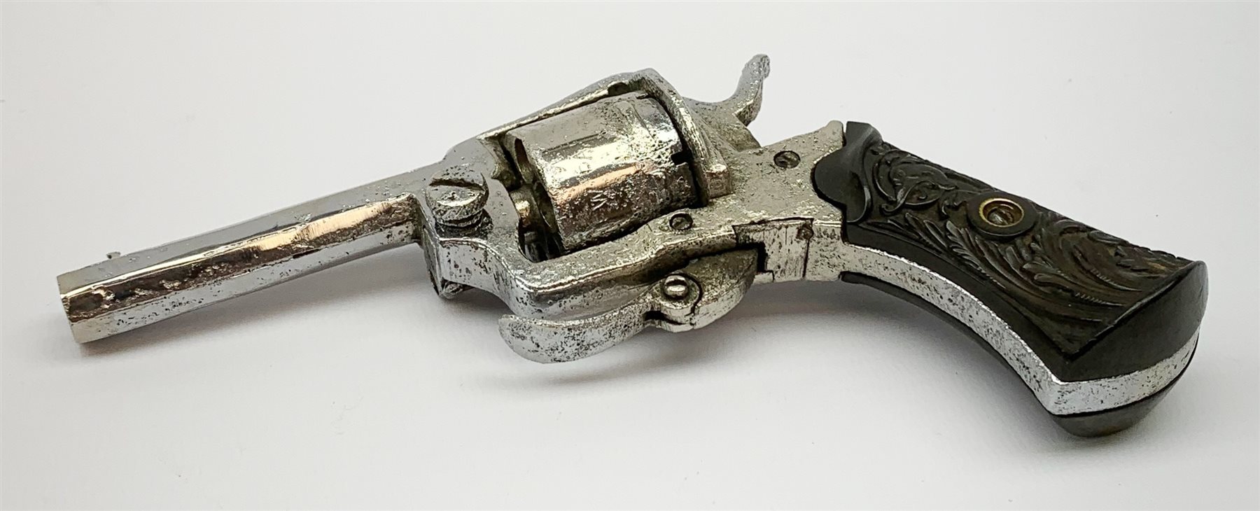 19th century plated Belgian 7mm pin-fire revolver, the six-shot cylinder inscribed 'The Young Lion 1881 New Pattern', with folding trigger and carved walnut split stock, barrel length 7.5cm, overall length 18.5cm