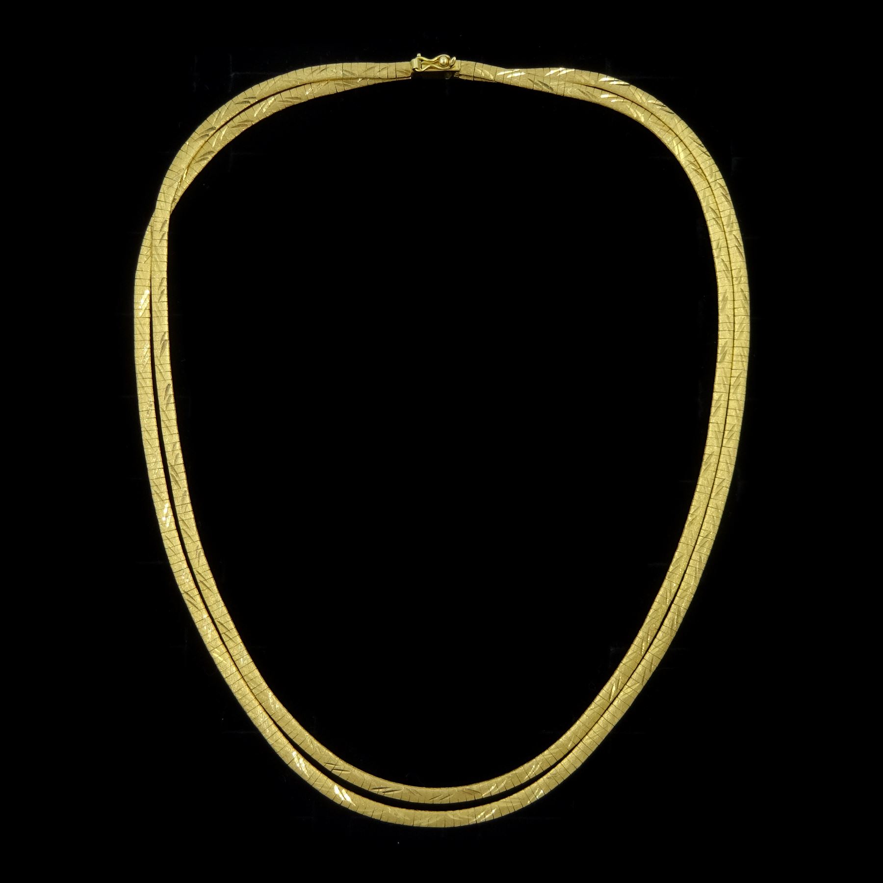 18ct gold three strand flattened link necklace, stamped 750