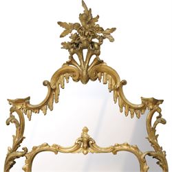 George III Chippendale design carved giltwood and gesso wall mirror, the impressive protruding pierced pediment decorated with flared acanthus leaves interspersed with flower heads and berries, over an arched outer-frame - the cresting comprised of C-scrolls carved with dripping icicle motifs, the uprights formed of scrolling acanthus with swags of grapevines and foliage, over a scrolled cartouche terminal, the inner-frame of architectural form with bell-flower details and a shaped cresting with scrolling acanthus leaves, all enclosing a central slightly bevelled rectangular mercury glass plate, surrounded by smaller plates