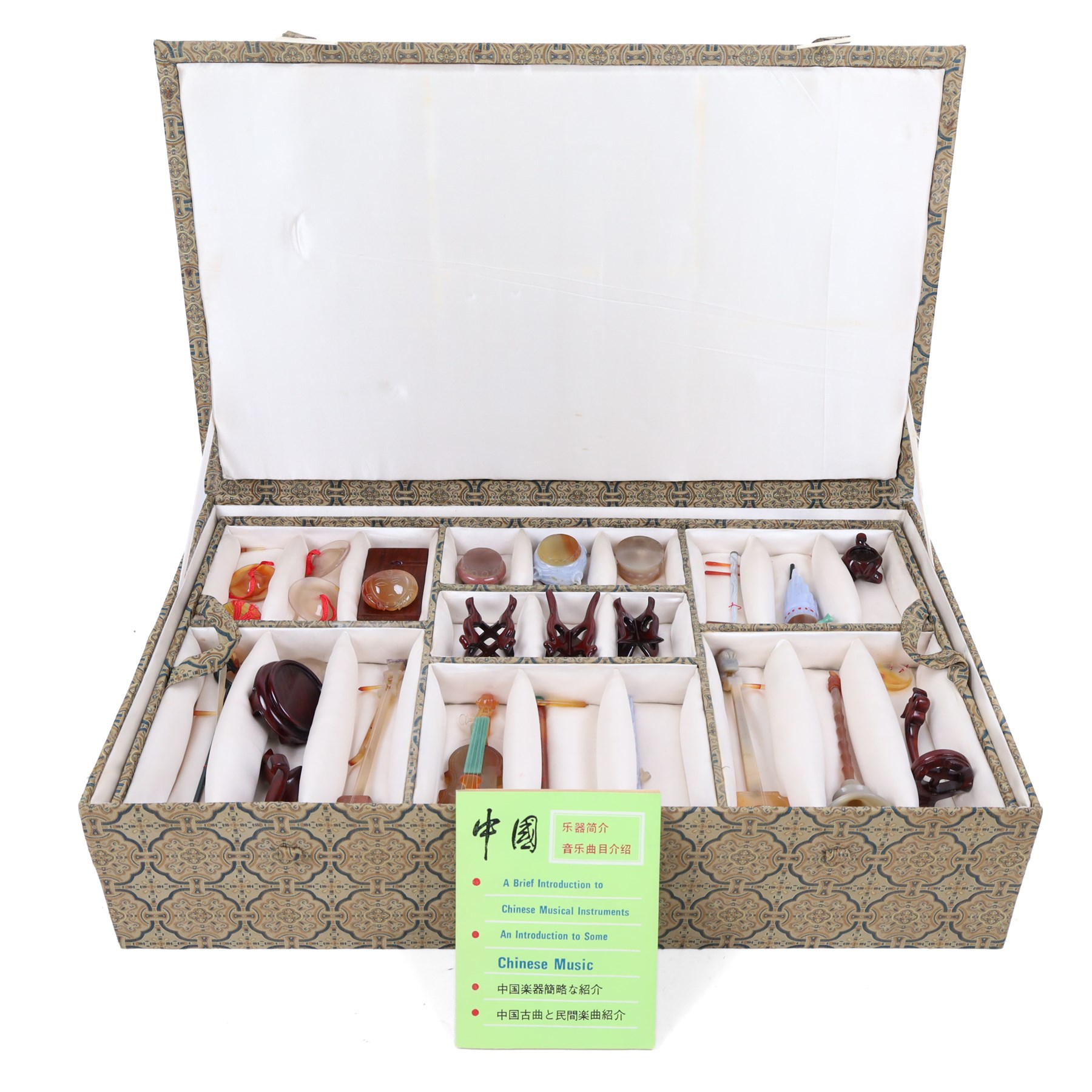 Boxed set of Chinese miniature polished hardstone musical instruments with hardwood stands