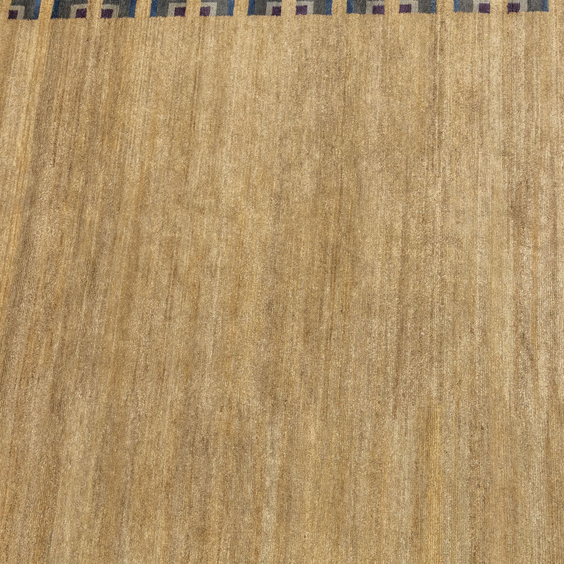Rugs by Design - ‘Silk Stone’ Nepalese thick pile wool rug, with plain textured camel ground and geometric border detail in blue, grey and dark tones to two sides