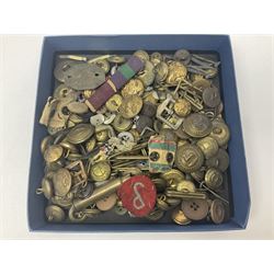 Over thirty British and Continental military metal badges; together with quantity of shoulder titles, collar dogs, rank pips, uniform buttons etc
