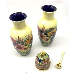 An Old Tupton Ware honey pot, of oval form with tube lined tendril decoration, the domed cover surmounted by a honey bee, with accompanying spoon, together with a pair of Old Tupton Ware vases, with tube lined sunflower decoration, H22cm, each with printed mark to base.