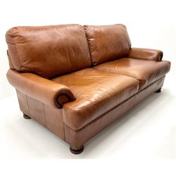 Three seat studded tan leather sofa, scrolling arms, turned supports (W190cm) with matching two seat (W155cm) armchair (W100cm) and footstool 
