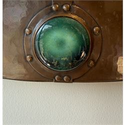 Liberty & Co, Arts and Crafts hammered copper framed oval wall mirror, mounted by four turquoise Ruskin cabochon roundels, with ivorine maker's label verso