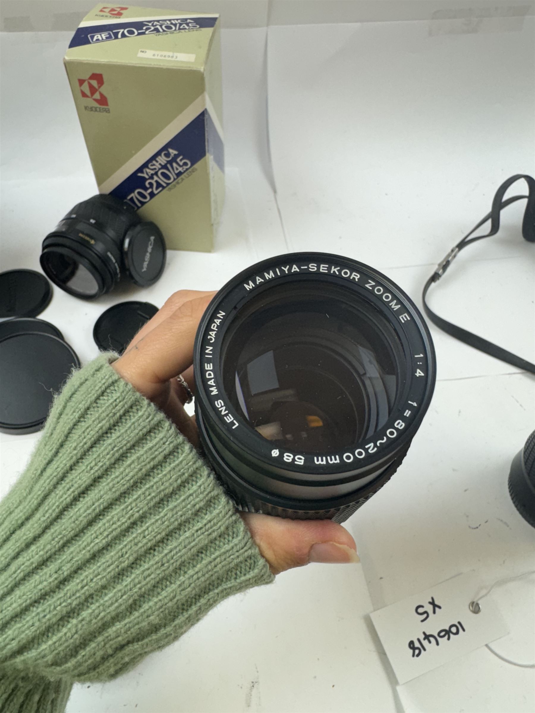 Group of camera lenses, comprising Yashica AF 70-210mm 1:4.5 58mm lens serial no. F6106983, boxed, Yashica AF 35-70mm 1:3.3-4.5 52mm Macro lens serial no. F60231147, Yashikor Aux Wide Angle 1:4 lens and a Yashikor Aux Tele-Photo 1:4 lens, Mamiya-Sekor E 1:2.8 f=28mm serial no. 13427 and a Mamiya-Sekor Zoom E 1:4 f=80-200mm lens serial no. 11271