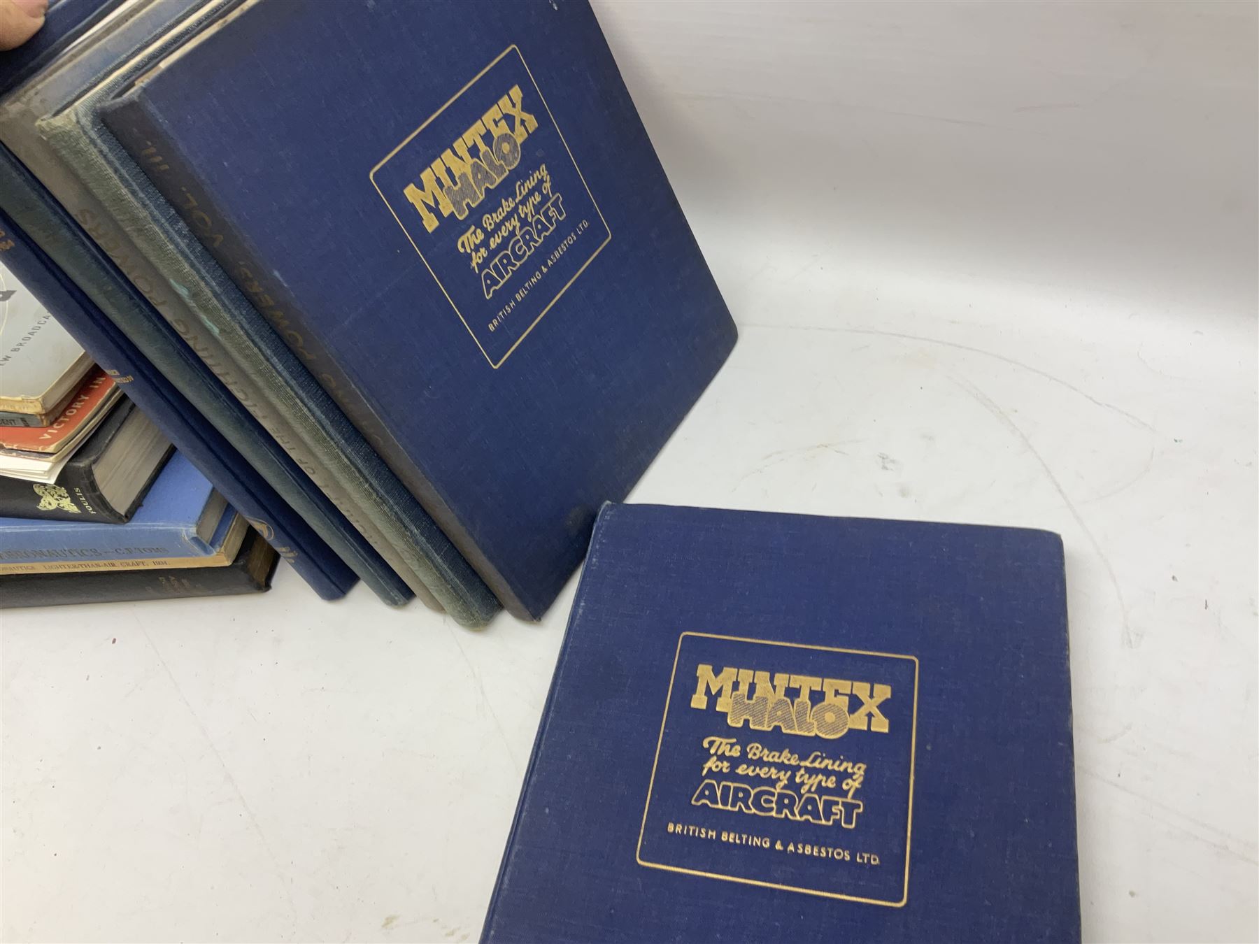 Aircraft of the Fighting Powers. Five volumes. 1940-44 including two copies of volume three; Royal Air Force Flying Review. Six volumes. 1956-63. Uniformly bound in blue cloth with gilt RAF crest to front covers; and ten other books of aircraft and aeronautica interest.