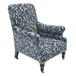  Victorian mahogany and beech framed armchair, turned front supports on brass and ceramic castors, upholstered in blue classical patterned chenille fabric, W73cm  