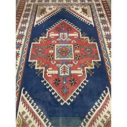 Turkish rug, blue ground field with large central medallion, four band border decorated with geometric motifs