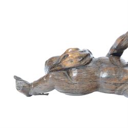 17th century carved figure of a putto, modelled with arms upstretched and head turned, approximately H64cm W23cm D27cm