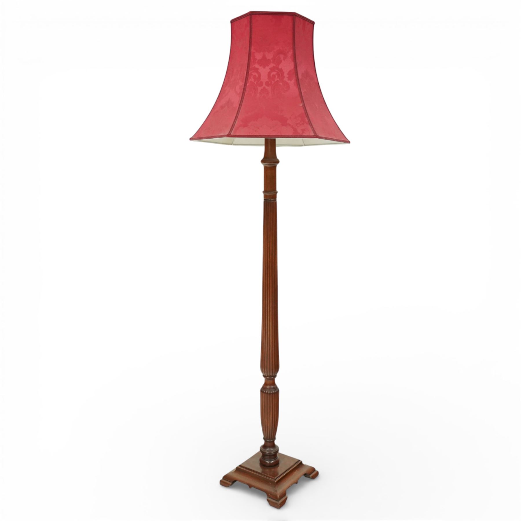 Hepplewhite design mahogany standard lamp, fluted column support with ring turned details, raised on a stepped square base with out-swept feet, fitted with a shaped red fabric lampshade